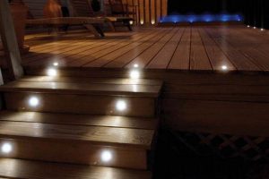 wooden deck steps with outdoor lighting